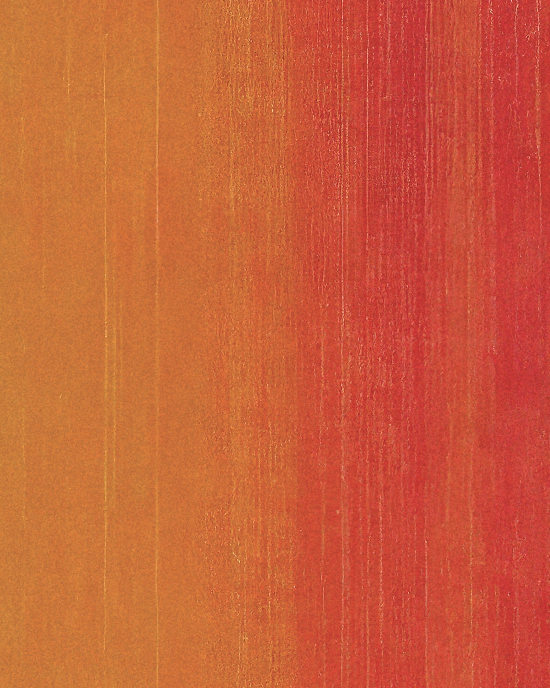 A close-up of a textured surface showing a vertical gradient transition from warm golden orange on the left to vibrant red on the right.